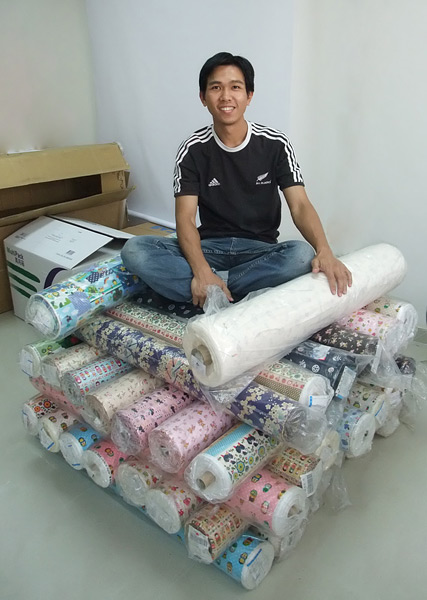 Kokka fabric bolts Alan sitting on our self-made Kokka fabric pyramid