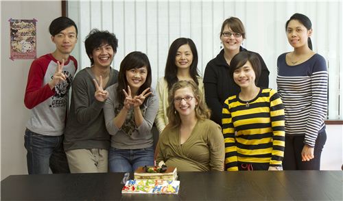 Smiles all around, everybody is looking forward to eating the cake