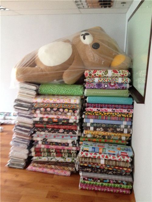 Big Rilakkuma relaxed well protected on a pile of fabrics while everybody else was working