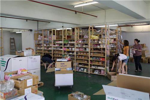 Another team is unpacking the boxes and puts the products back to the shelves