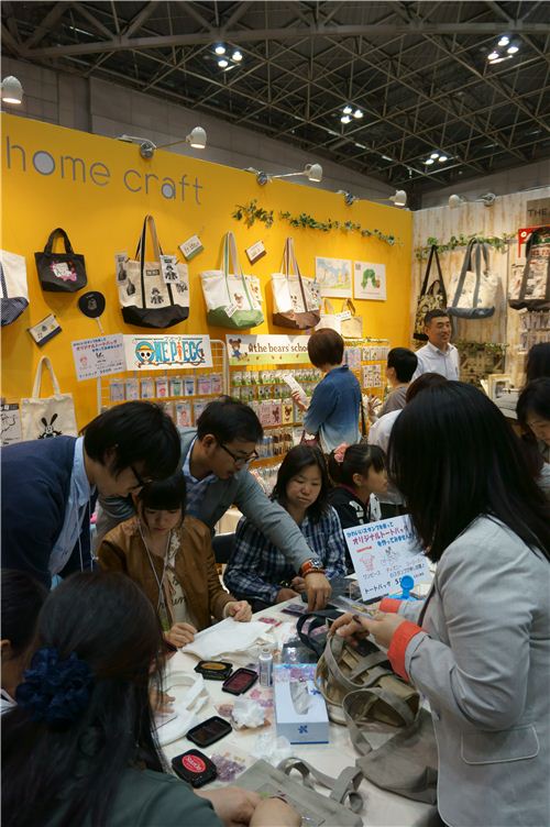 Here people are using fabric paint to stamp on tote bags