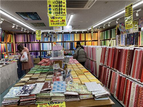 We love how the fabrics are mostly arranged by color here